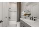 Modern bathroom with a white vanity, granite countertop, gray fixtures, and shower-tub combination at 1687 Ruby Ln, Lake Alfred, FL 33850