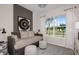 Cozy bedroom featuring neutral tones, a decorative accent wall, and a bright window with a view of the neighborhood at 1687 Ruby Ln, Lake Alfred, FL 33850