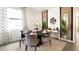 Elegant dining area with modern decor, decorative plants, a large window, and neutral accents at 2276 Red Sun St, Apopka, FL 32703