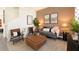 Warm living room featuring neutral tones, comfortable seating, decorative lamps, and stylish decor at 2276 Red Sun St, Apopka, FL 32703