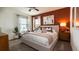Relaxing main bedroom features a decorative accent wall, plush bedding, and bright natural light at 2276 Red Sun St, Apopka, FL 32703