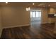 Open dining area with modern chandelier lighting and wood-look floors connecting to kitchen and sunroom at 3821 Whitedove Dr, Lakeland, FL 33812