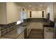 Modern kitchen with white cabinets, granite countertops, stainless steel appliances, and mosaic tile backsplash at 3821 Whitedove Dr, Lakeland, FL 33812