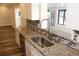 Bright kitchen featuring granite counters, stainless steel sink, stainless steel appliances, and white cabinets at 3821 Whitedove Dr, Lakeland, FL 33812