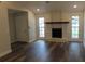 Spacious living room featuring wood-look floors, white brick fireplace, recessed lighting, and large windows at 3821 Whitedove Dr, Lakeland, FL 33812