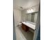 Bathroom with a vanity featuring a marble countertop and a neutral-colored tile floor at 4516 Casablanca Ave, Kissimmee, FL 34746