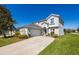 Two-story home with a well-maintained lawn, attached garage, and attractive curb appeal at 622 Copeland Dr, Haines City, FL 33844