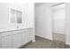 Bright bathroom featuring a white vanity with modern fixtures and a separate walk-in closet space at 13276 Tula Loop, Astatula, FL 34705