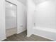 Clean, well lit bathroom featuring a tub with white tiled walls and an open view to a closet at 13276 Tula Loop, Astatula, FL 34705