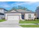 Charming single-Gathering home featuring a two-car garage, well-manicured lawn, and covered front entry at 13276 Tula Loop, Astatula, FL 34705