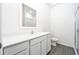 Modern bathroom with white vanity, a large mirror, and a glass-enclosed shower at 13438 Leaping Water Way, Astatula, FL 34705