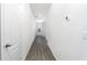 Bright hallway featuring gray floors and white walls, leading to various rooms at 13438 Leaping Water Way, Astatula, FL 34705