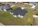 An aerial view of a single-Gathering home with a dark roof and spacious green lawn in a residential neighborhood at 2840 Sw 166 Th Ln, Ocala, FL 34473
