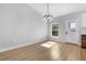 Dining room features modern lighting, wood floors, and a large window with a view to the backyard at 2840 Sw 166 Th Ln, Ocala, FL 34473