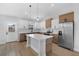 Modern kitchen featuring white and wood cabinets, stainless steel appliances, and a center island with pendant lighting at 2840 Sw 166 Th Ln, Ocala, FL 34473