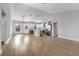 Bright, open-concept living space with modern wood flooring and a view into the stylish, updated kitchen at 2840 Sw 166 Th Ln, Ocala, FL 34473