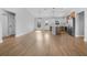 Open-concept living space with stylish wood flooring, bright windows, and a modern kitchen visible in the background at 2840 Sw 166 Th Ln, Ocala, FL 34473
