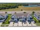 An aerial view showcases a meticulously planned community with garage parking and nearby lake at 3926 Grassland Dr, Orlando, FL 32824