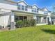 A well-maintained backyard featuring a covered patio area and lush green lawn at 3926 Grassland Dr, Orlando, FL 32824