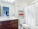Bathroom featuring a vanity with a sink, toilet, shower with curtain, and tile floor at 3926 Grassland Dr, Orlando, FL 32824