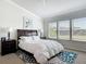 Bright bedroom featuring a large bed, modern lamps, and three windows for ample natural light at 3926 Grassland Dr, Orlando, FL 32824