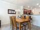 The dining area features an elegant chandelier, hardwood table, and seamless flow to the kitchen at 3926 Grassland Dr, Orlando, FL 32824