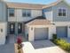 Charming townhome exterior with private garage and manicured landscaping at 3926 Grassland Dr, Orlando, FL 32824