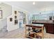 Kitchen view featuring an island, wood-look floors, stainless appliances, and an open concept to the dining and living room at 3926 Grassland Dr, Orlando, FL 32824