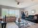 Comfortable living area with a ceiling fan, providing relaxation and access to outdoor scenery at 3926 Grassland Dr, Orlando, FL 32824