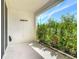 Covered patio area with a view of hibiscus and green landscaping at 3926 Grassland Dr, Orlando, FL 32824