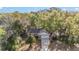 Aerial view of property, showcasing wooded lot and driveway at 39832 N Hibiscus Way, Lady Lake, FL 32159