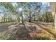 Expansive backyard surrounded by mature trees, offering ample space for outdoor activities and relaxation at 39832 N Hibiscus Way, Lady Lake, FL 32159