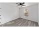 Bedroom with grey laminate flooring, white trim, and a ceiling fan at 39832 N Hibiscus Way, Lady Lake, FL 32159