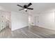 Bedroom features a ceiling fan, white trim, gray wood-look floors, and ensuite bathroom access at 39832 N Hibiscus Way, Lady Lake, FL 32159