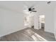 Bedroom boasts a ceiling fan, gray wood-look floors, an ensuite bathroom, and access to a walk-in closet at 39832 N Hibiscus Way, Lady Lake, FL 32159