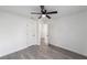 A view of a bedroom with light grey floors and white doors at 39832 N Hibiscus Way, Lady Lake, FL 32159