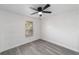 Bright bedroom with grey laminate flooring and a ceiling fan at 39832 N Hibiscus Way, Lady Lake, FL 32159