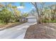 Front of home with driveway, two-car garage, and flag at 39832 N Hibiscus Way, Lady Lake, FL 32159