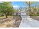 Well-maintained single-Gathering home with a spacious driveway and lush front yard, ideal for comfortable living at 39832 N Hibiscus Way, Lady Lake, FL 32159
