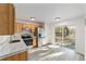 Modern kitchen featuring stainless steel appliances, light wood cabinetry, and sliding glass doors for seamless indoor-outdoor living at 39832 N Hibiscus Way, Lady Lake, FL 32159