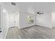 Bright, newly renovated living room showcasing neutral paint, modern flooring, ceiling fan, and lots of natural light at 39832 N Hibiscus Way, Lady Lake, FL 32159