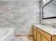 Bathroom featuring double vanity, granite counters, and tiled walls at 774 Lobelia Dr, Davenport, FL 33837