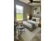Serene bedroom with a gray color scheme and view of a large window at 774 Lobelia Dr, Davenport, FL 33837