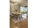 Bright dining area with sliding glass doors, a modern chandelier, and seating for four at 774 Lobelia Dr, Davenport, FL 33837