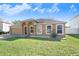 Charming single-story home featuring an attached two-car garage and a well-maintained lawn at 774 Lobelia Dr, Davenport, FL 33837