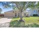 Charming single-story home featuring an attached two-car garage and a well-maintained lawn at 774 Lobelia Dr, Davenport, FL 33837