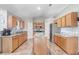 Spacious kitchen with wood cabinets, granite countertops, stainless steel appliances, and a central island at 774 Lobelia Dr, Davenport, FL 33837