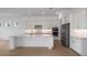 Bright, white kitchen features a large island, stainless steel appliances, and modern backsplash at 8734 Sw 55Th Street Rd, Ocala, FL 34481