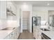 Kitchen featuring white cabinets, stainless steel appliances, tile backsplash, and pantry at 8734 Sw 55Th Street Rd, Ocala, FL 34481