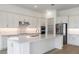 Spacious kitchen with white cabinetry, stainless steel appliances, and a large center island at 8734 Sw 55Th Street Rd, Ocala, FL 34481